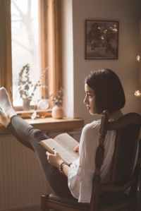 photo of woman holding book